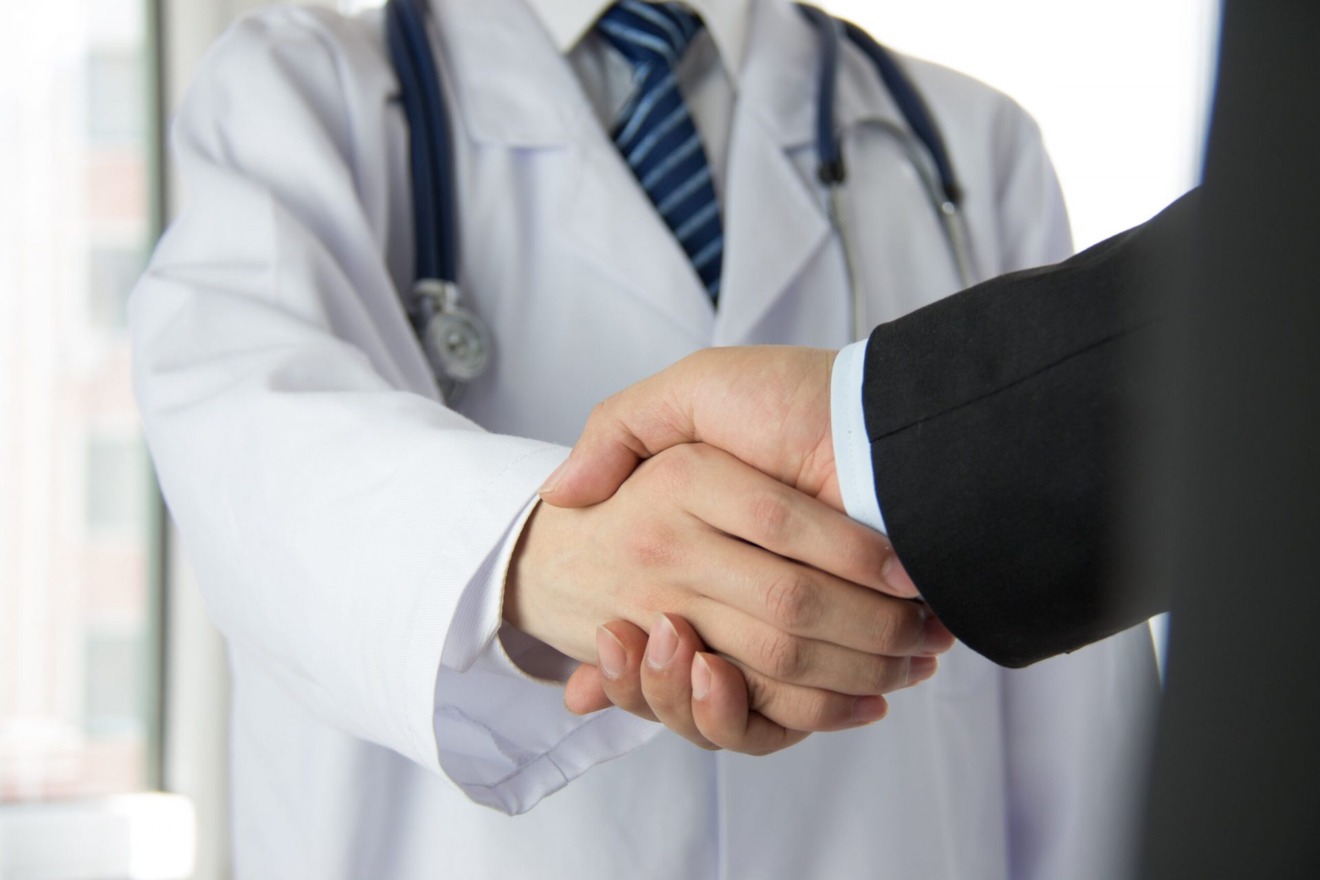 Doctor,And,Businessman,Shaking,Hands